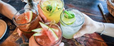 Friends,Toasting,,Saying,Cheers,Holding,Tropical,Blended,Fruit,Margaritas.,Watermelon